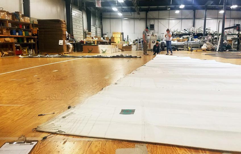 A sail being inspected on the loft floor