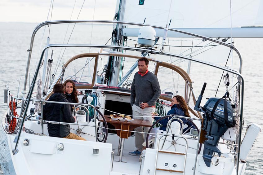 Cruising sailors having dinner on the deck of a yacht.