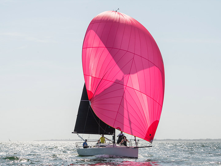 A J/88 flying a pink spinnaker
